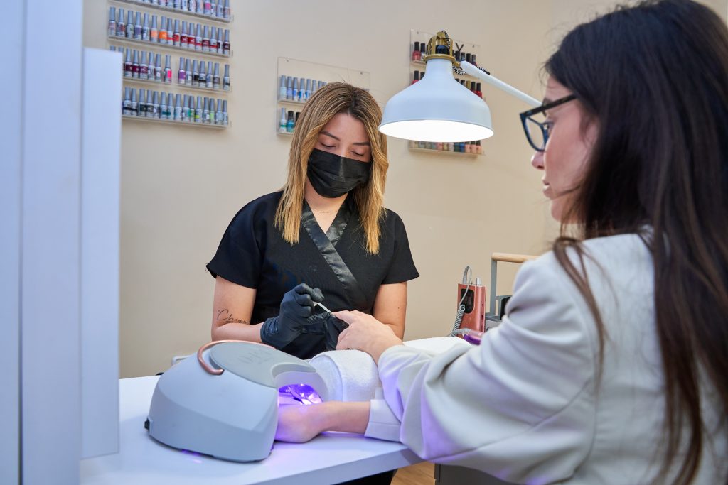 Professional of a beauty salon doing the nails of a customer.  Nail Salons in Toronto ON (2025) .