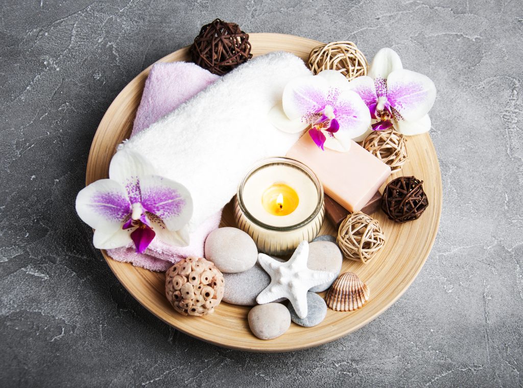 Spa products with orchids on a old gray stone background