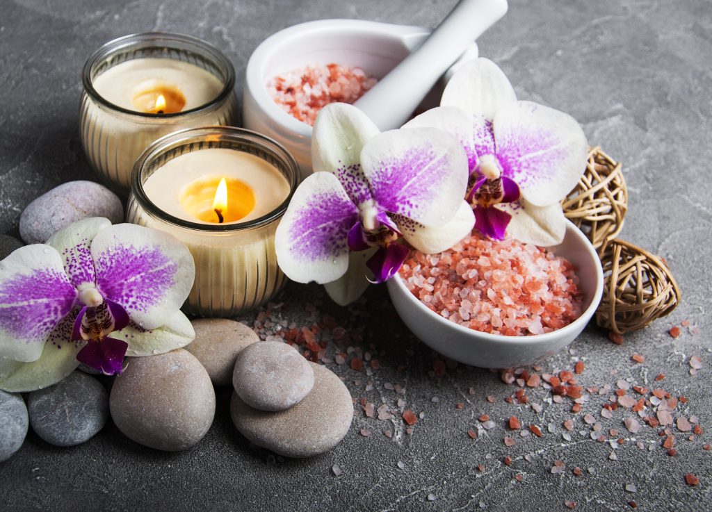 Spa products with orchids on a old gray stone background
