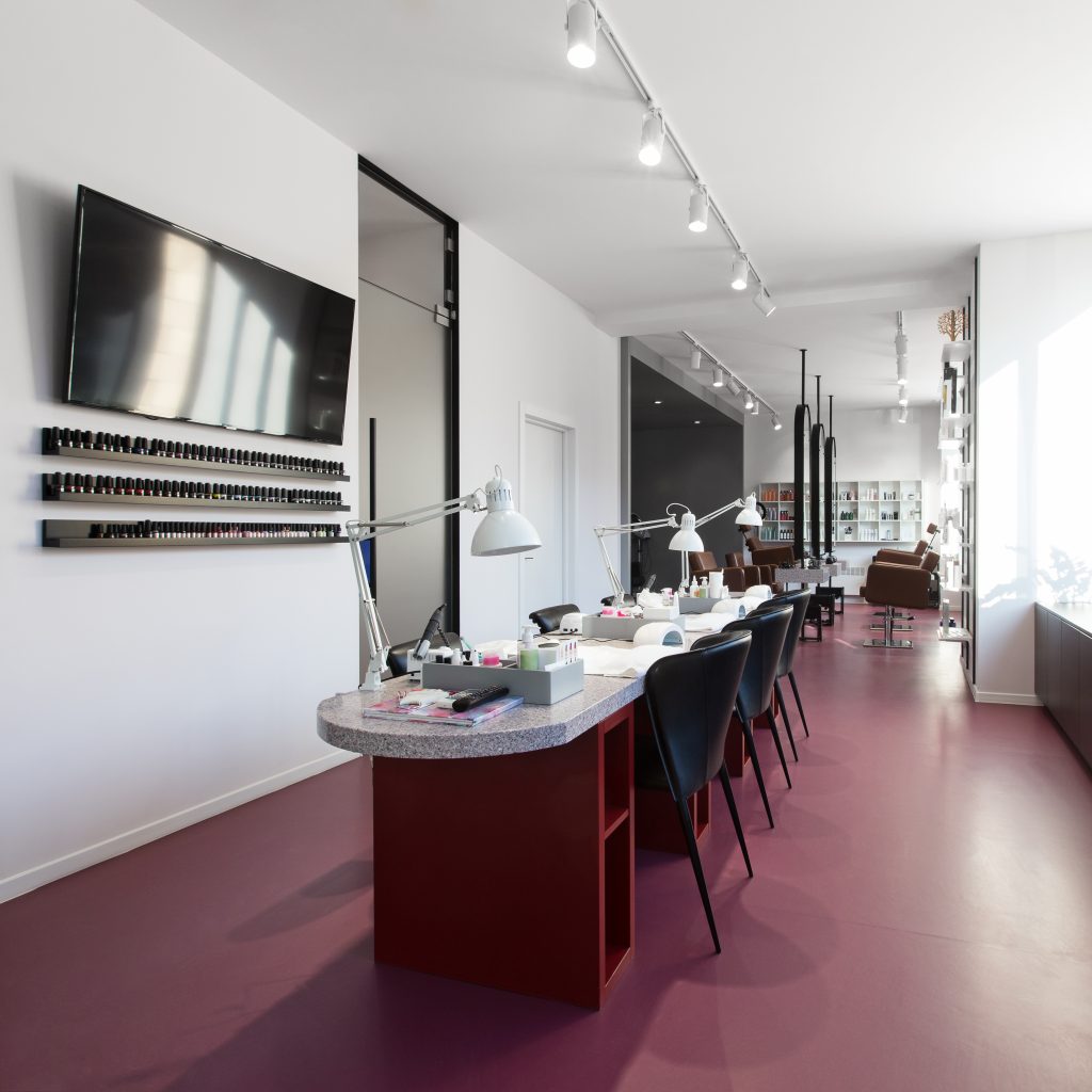 Beauty salon, no people. Interior of empty modern nail salon. Workplaces for masters of manicure. Pedicure cabinet.