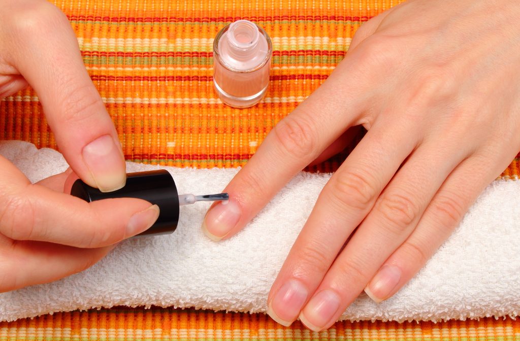 woman-doing-a-manicure-applying-clear-nail-polish-2026-09-22-10-18-35-utc
